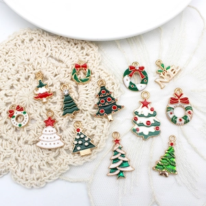Christmas alloy enamel charms set featuring Santa, trees and wreaths on white plate