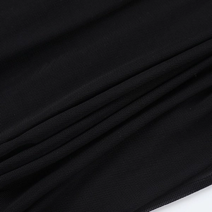 Macro view of the breathable black mesh fabric texture showing delicate sheer details