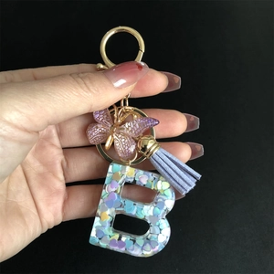 Resin letter B keychain with colorful heart sequins, purple tassel and butterfly charm
