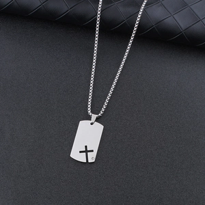 Minimalist silver dog tag necklace with cross cutout and small diamond on black leather