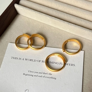 Set of four minimalist matte gold open rings for women displayed in a premium gift box