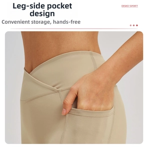 Detail of high waisted yoga shorts featuring a V-shaped cross waist and functional side pockets