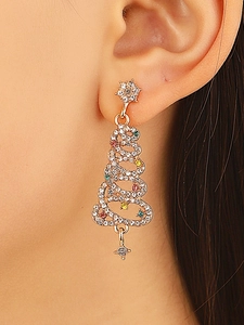 Macro view of Christmas tree earrings with colorful crystals and gold plating