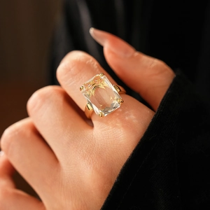 Macro close-up of a 14k gold plated square zircon ring worn by a model on finger