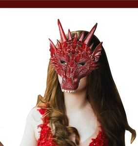 Detail of red 3D dragon mask with realistic scale textures and white fangs on female model