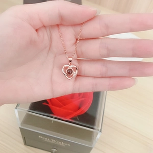 Rose gold heart projection necklace with red rose gift box and matching carrier bag