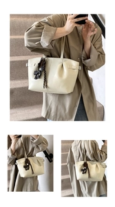 Detail shots of beige pleated tote bag with cat charm showing various wearing angles
