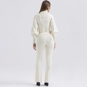 Detail of cream knit set featuring lantern sleeves and asymmetric collar back view