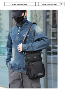Detail of black tactical nylon shoulder bag with multi-layer pockets and buckle straps