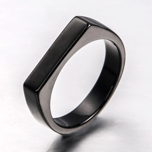 Close-up of a black matte stainless steel signet ring with a flat top and satin finish