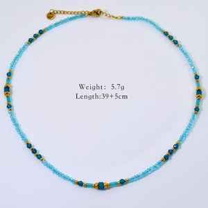 Detail view of handmade beaded necklace with sky blue crystal beads and golden steel clasp
