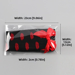 Detailed dimension view of black stockings with red lip prints and festive bow decoration