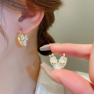 Elegant gold heart earrings with white zircon flowers for women in warm lighting