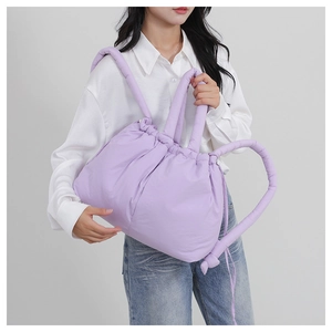 Detail of lavender nylon tote bag featuring thick cloud-style handle and drawstring closure