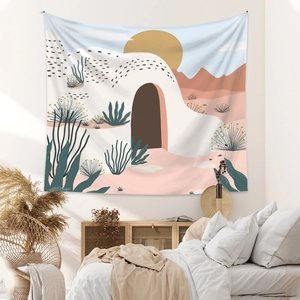 Detail of Boho desert landscape tapestry featuring abstract mountains and sunset on white wall