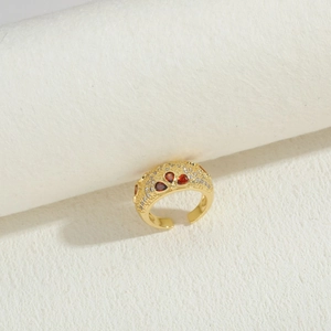 Detailed shot of gold-plated open ring with red heart gems and sparkling zircons
