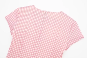 Detail of pink gingham dress featuring a hidden back zipper and fine textured fabric