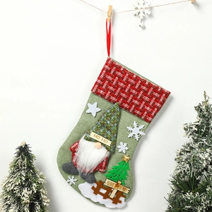 Detail of green burlap Christmas stocking with gnome, tree and Merry Christmas sign