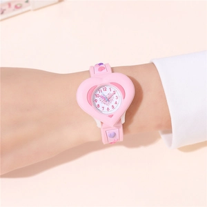 Pink heart-shaped children's watch with 3D decorative silicone strap shown on wrist