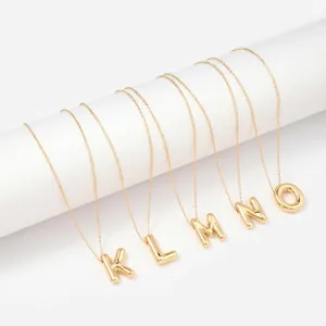 Gold balloon style initial necklaces with K L M N O letters in polished stainless steel