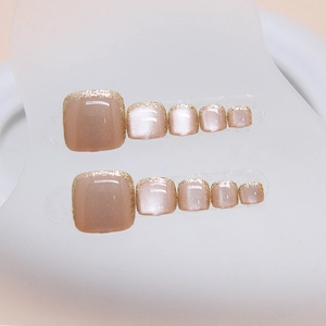French cat eye press-on toenails with champagne gold glitter tips on display card