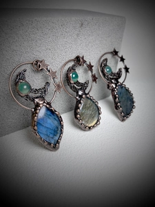 Detailed view of handmade copper wire-wrapped pendants with moon and star labradorite