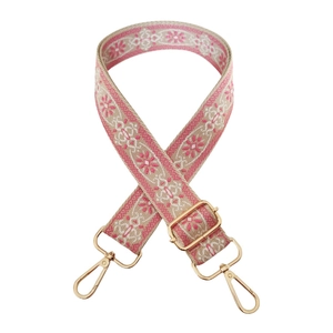 Close-up of ethnic style 3.8cm wide strap with pink floral embroidery and gold metal hooks