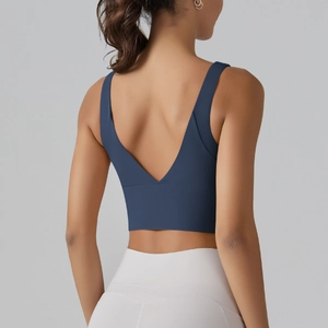 Detail view of the deep V-back design and wide supportive hem on dark blue sports bra