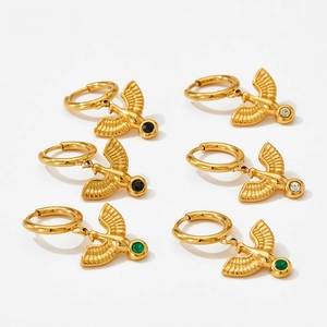 Detailed view of three pairs of golden bird hoop earrings with colorful zircon stones