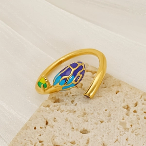 Artistic gold-plated open ring with vibrant colorful leaf patterns on stone background