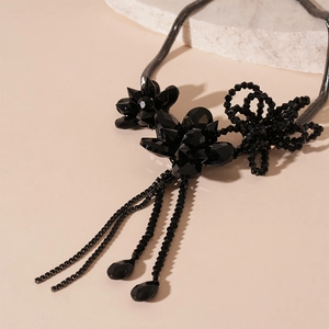 Close-up of gothic black flower glass bead tassel necklace with detailed metal chains