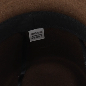 Close-up of the 100% polyester fabric label and sweatband inside the wool felt hat