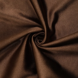 Detailed close-up of brown textured fabric with soft knit patterns on backless dress