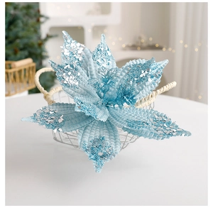 Close-up of light blue velvet Christmas flower with silver glitter details in a basket