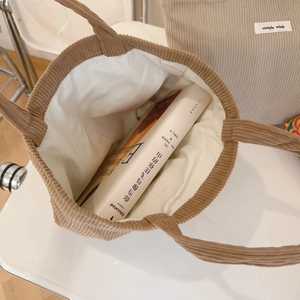 Detail of camel corduroy tote bag showing interior lining and simple wish woven label