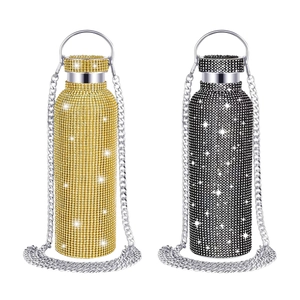 Detail of gold and black diamond-encrusted tumblers with silver metal chains