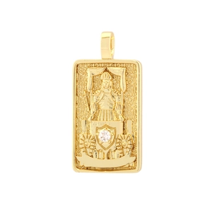 Macro shot of gold-plated rectangular tarot pendant with Egyptian sphinx and white zircon