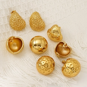 Set of four vintage gold titanium steel stud earrings with textured metallic finishes