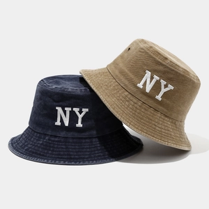 Washed cotton bucket hats in navy and khaki with white NY embroidery in a flat lay view