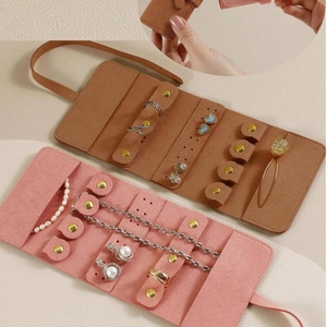 Pink and brown velvet jewelry roll organizers showing ring slots and earring holders