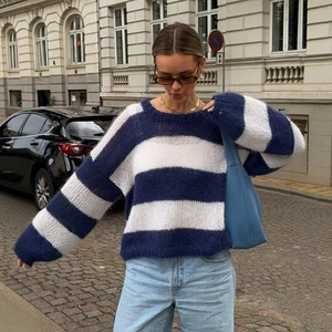 Women's blue and white striped oversized knit sweater in a casual urban street style look