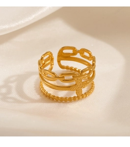 Detailed macro of 18K gold plated chain ring with cross flower on silk fabric