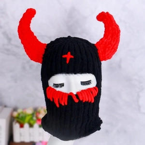 Detail of knitted balaclava with red devil horns and facial embroidery for Halloween
