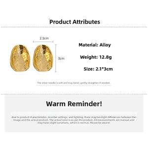 Detailed view of irregular textured gold earrings with dimensions 2.1x3cm and silver posts