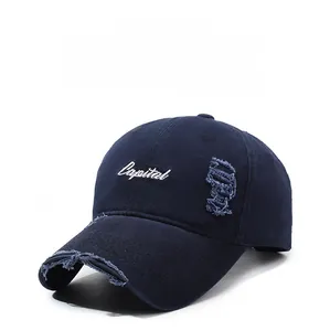 Close-up of distressed brim and Capital embroidery on vintage navy baseball cap