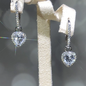 Sparkling heart-shaped drop earrings with clear zircon stones in a silver-tone setting