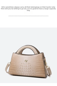 Detail of beige crocodile pattern handbag with gold V-logo and metallic buckle strap