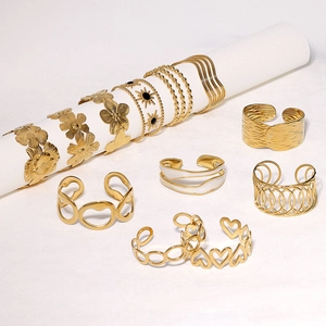 9-piece gold stainless steel jewelry set featuring heart, flower and star geometric motifs
