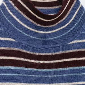 Close-up of high turtleneck striped knit top with multi-color retro pattern details
