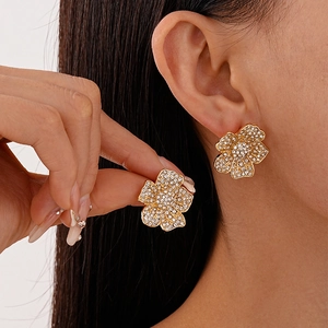 Elegant gold flower stud earrings with sparkling crystals for a luxury minimalist look
